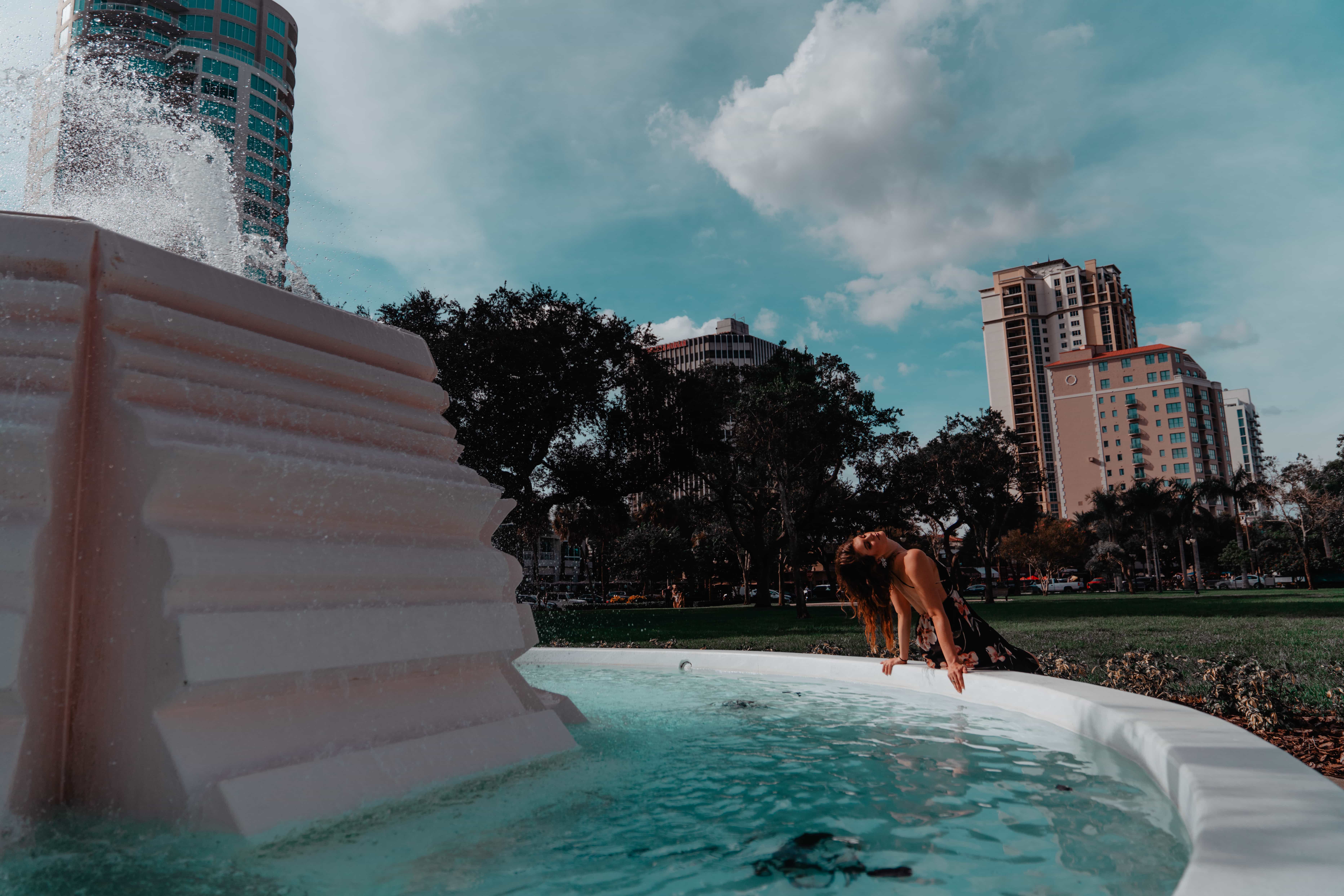 Aimee Albright wearig dress at the water fountain in south straub park st pete