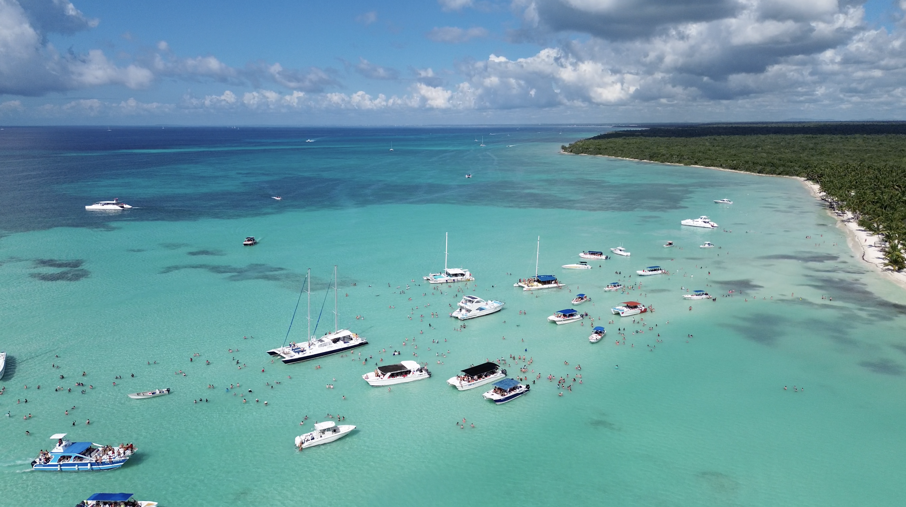 boats in clear blue water near saona island in the dominican republic